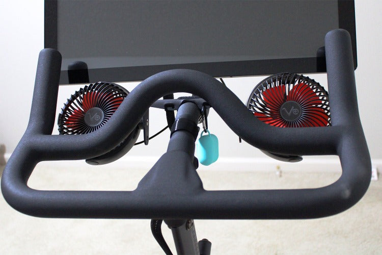 
                  
                    aqua airpod case cover hanging from fan kit on Peloton
                  
                