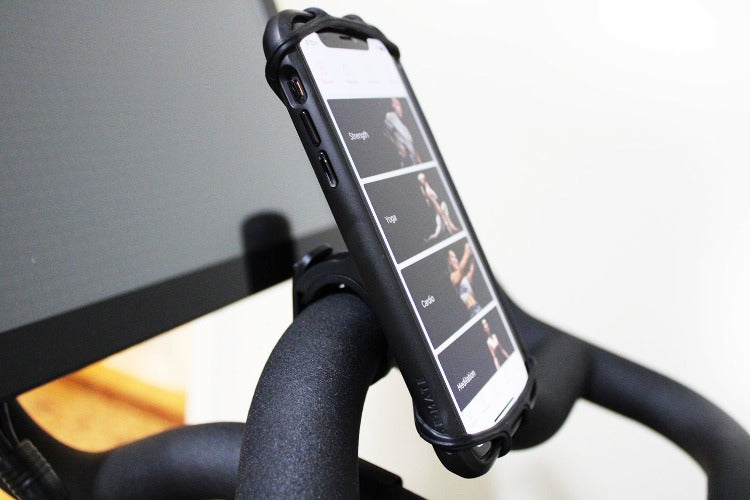 Smart phone mounted to handlebar via phone holder in vertical position