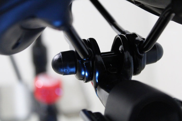 
                  
                    Close up of saddle clamp bolt covers underneath Peloton bike
                  
                